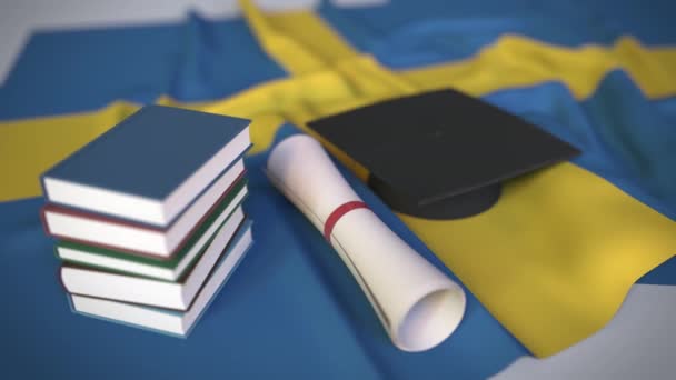 books, graduation cap and flag of Sweden
