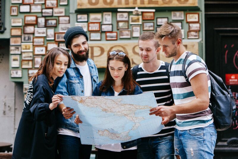 A group of international students looking at map's boundaries
